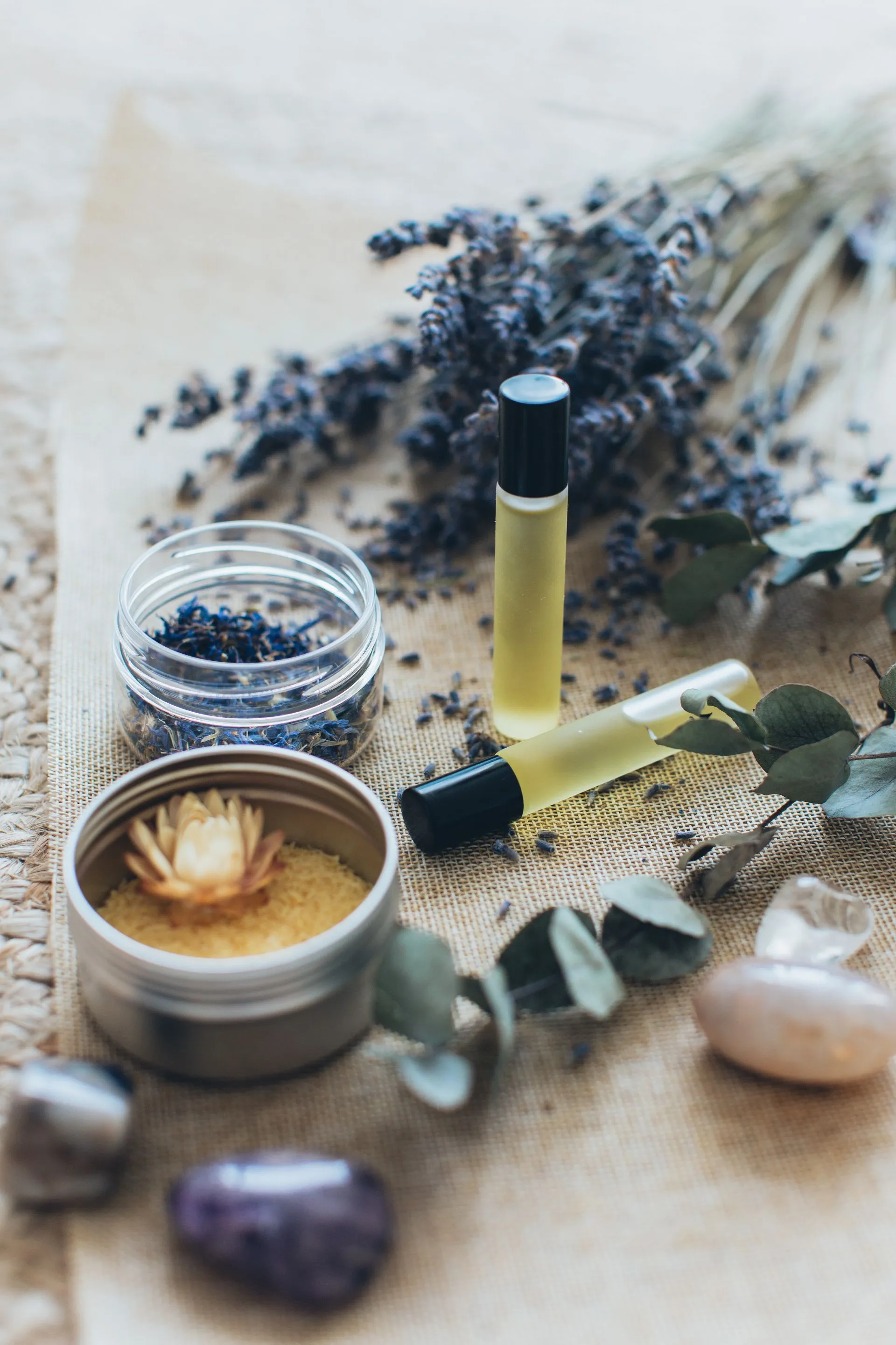 Lavender and a fragrance roller among soft botanicals
