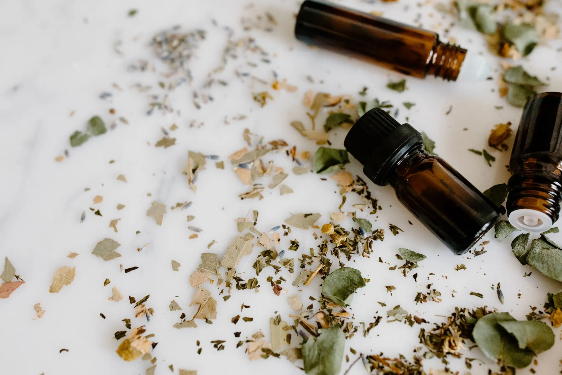 Amber dropper bottle among dried botanicals